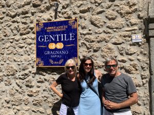 Jeanie, Ashley and Michael Coates pose outside of the Gentile Pastificio building in Nunzio, Italy.