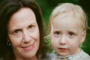 Photo of a grandmother and her grand-daughter outside. Portrait shot on Kodak Portra 400 Professional film with the Nikon F, 50mm 1.4.