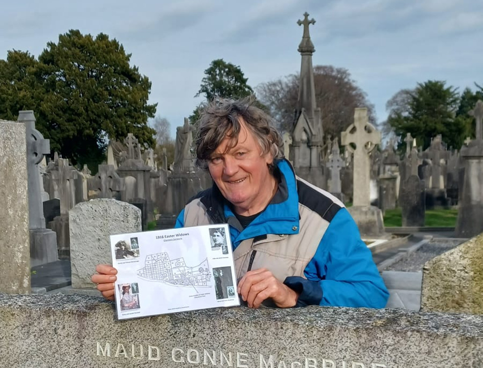 Martin Mooney holds up one of his maps in Glasnevin Cemetery