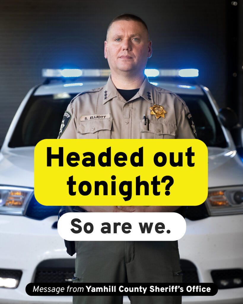 Picture of the Yamhill County Sheriff standing in front of a police car. Text is overlaid on the image and reads - Heading out tonight? So are we. Smaller text reads, Message from Yamhill County Sheriff's Office.